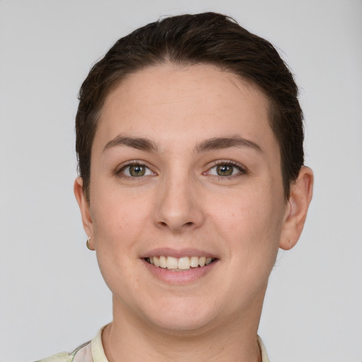 Joyful white young-adult female with short  brown hair and grey eyes