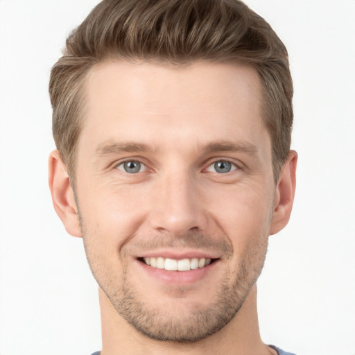 Joyful white young-adult male with short  brown hair and grey eyes