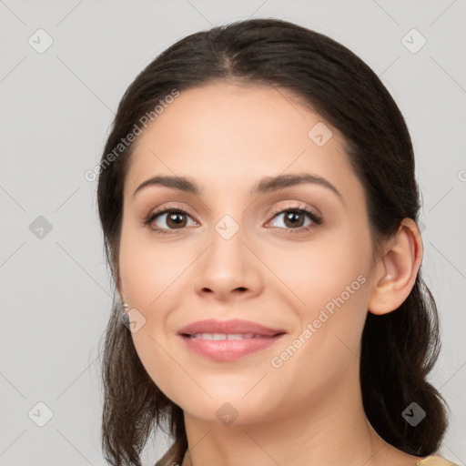 Joyful white young-adult female with long  brown hair and brown eyes