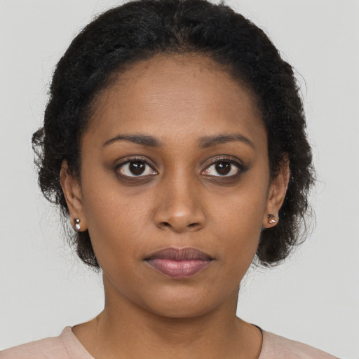 Neutral black young-adult female with long  brown hair and brown eyes