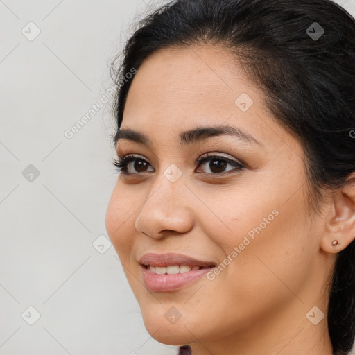 Joyful latino young-adult female with long  brown hair and brown eyes