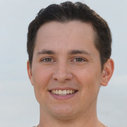 Joyful white young-adult male with short  brown hair and brown eyes