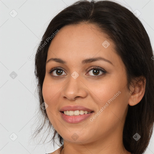 Joyful white young-adult female with long  brown hair and brown eyes