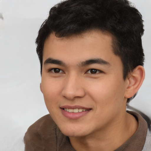 Joyful latino young-adult male with short  brown hair and brown eyes