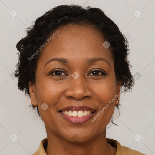 Joyful black adult female with medium  brown hair and brown eyes