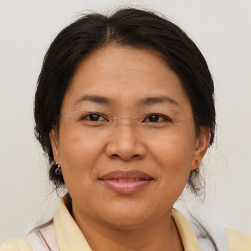 Joyful asian adult female with medium  brown hair and brown eyes