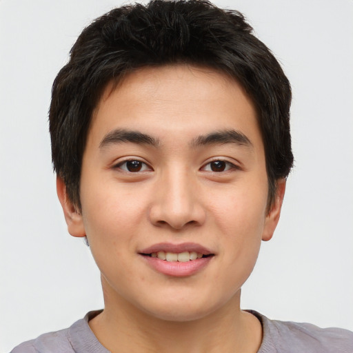 Joyful asian young-adult male with short  brown hair and brown eyes