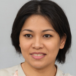 Joyful asian young-adult female with medium  brown hair and brown eyes