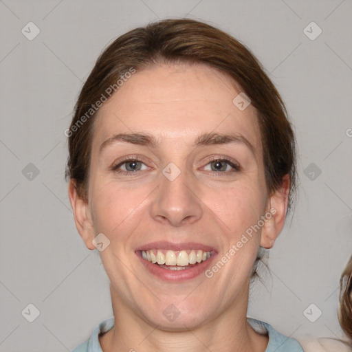 Joyful white adult female with medium  brown hair and blue eyes