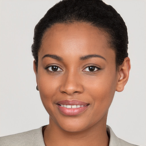 Joyful black young-adult female with short  brown hair and brown eyes