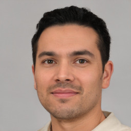 Joyful white young-adult male with short  black hair and brown eyes