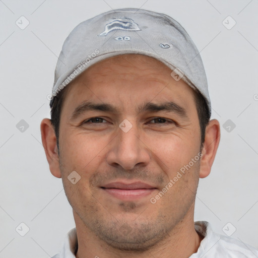 Joyful white adult male with short  brown hair and brown eyes