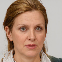 Joyful white adult female with medium  brown hair and grey eyes