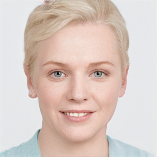 Joyful white young-adult female with short  blond hair and blue eyes