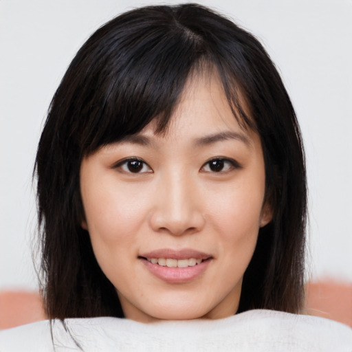 Joyful asian young-adult female with medium  brown hair and brown eyes
