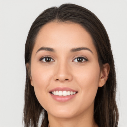 Joyful white young-adult female with long  brown hair and brown eyes