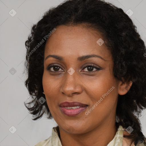 Joyful black adult female with medium  brown hair and brown eyes