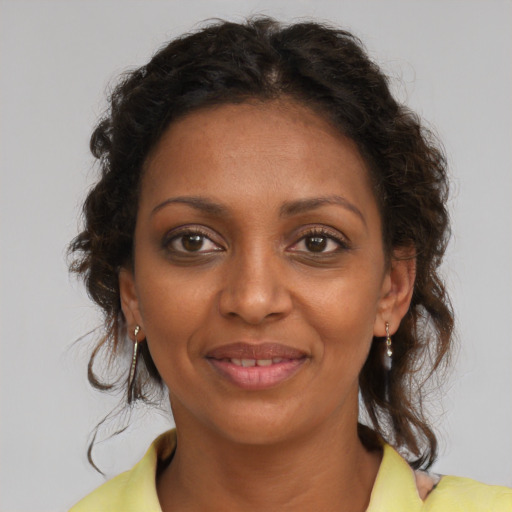 Joyful black young-adult female with medium  brown hair and brown eyes