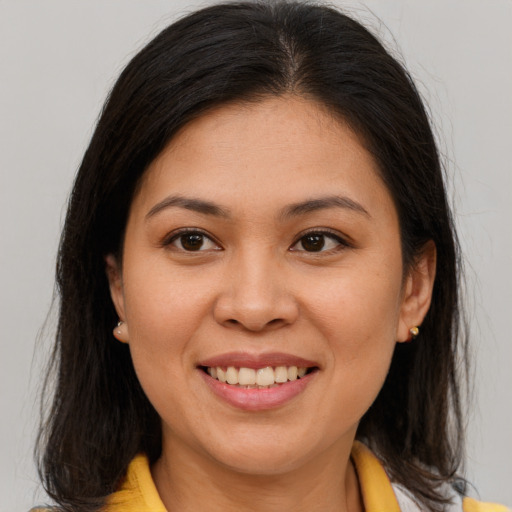 Joyful asian young-adult female with medium  brown hair and brown eyes