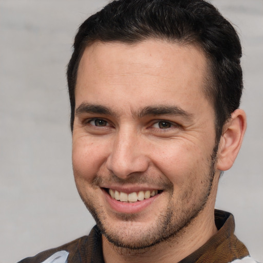 Joyful white young-adult male with short  brown hair and brown eyes