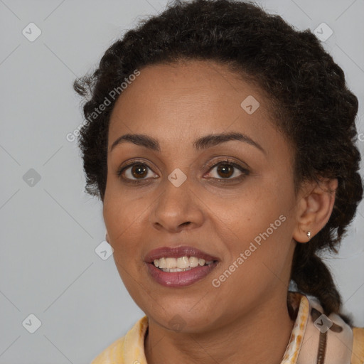 Joyful black young-adult female with short  brown hair and brown eyes