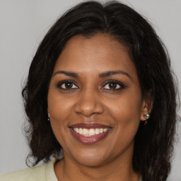 Joyful black young-adult female with medium  brown hair and brown eyes