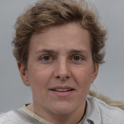 Joyful white adult female with short  brown hair and grey eyes