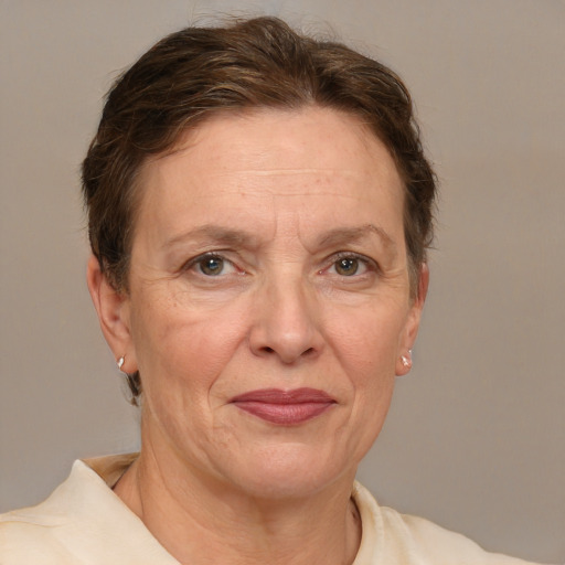 Joyful white adult female with short  brown hair and grey eyes