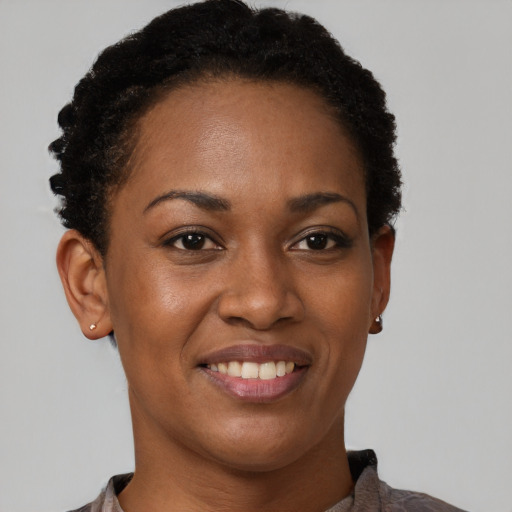 Joyful black young-adult female with short  brown hair and brown eyes