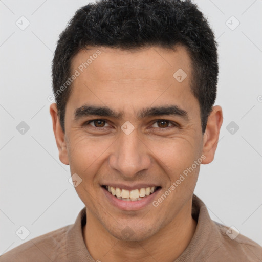 Joyful latino young-adult male with short  brown hair and brown eyes