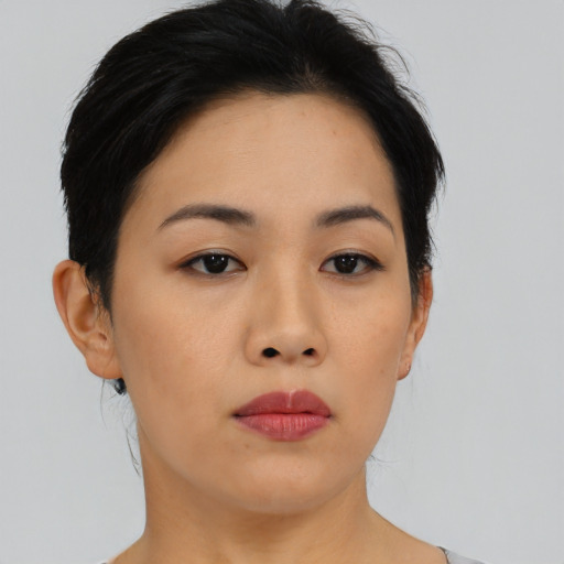 Joyful asian young-adult female with short  black hair and brown eyes