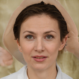 Joyful white adult female with medium  brown hair and brown eyes