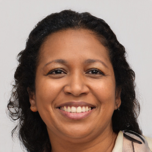Joyful latino adult female with long  brown hair and brown eyes
