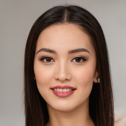 Joyful white young-adult female with long  brown hair and brown eyes