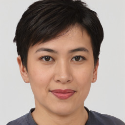 Joyful asian young-adult female with short  brown hair and brown eyes