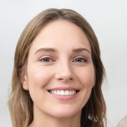 Joyful white young-adult female with long  brown hair and grey eyes