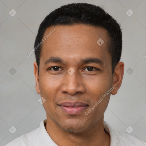 Joyful latino adult male with short  black hair and brown eyes