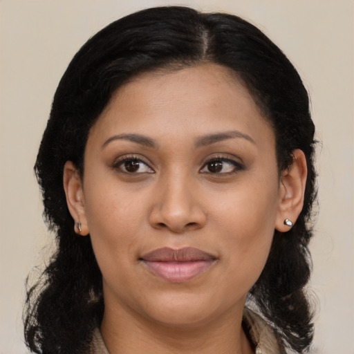 Joyful latino young-adult female with medium  brown hair and brown eyes