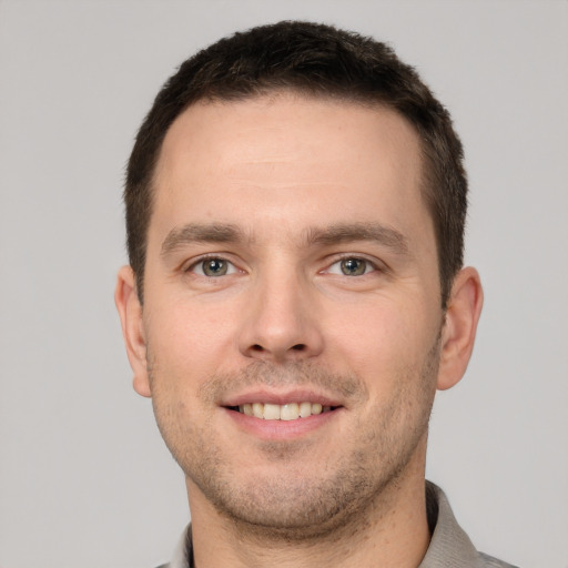 Joyful white young-adult male with short  brown hair and brown eyes