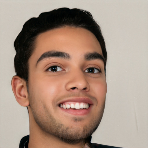 Joyful white young-adult male with short  black hair and brown eyes