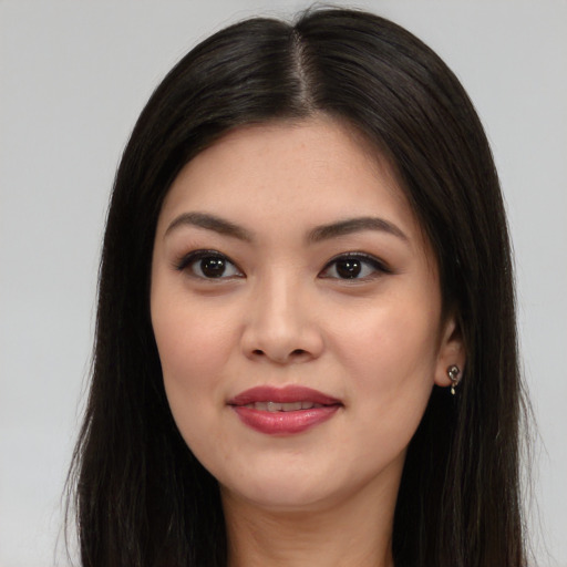 Joyful asian young-adult female with long  brown hair and brown eyes