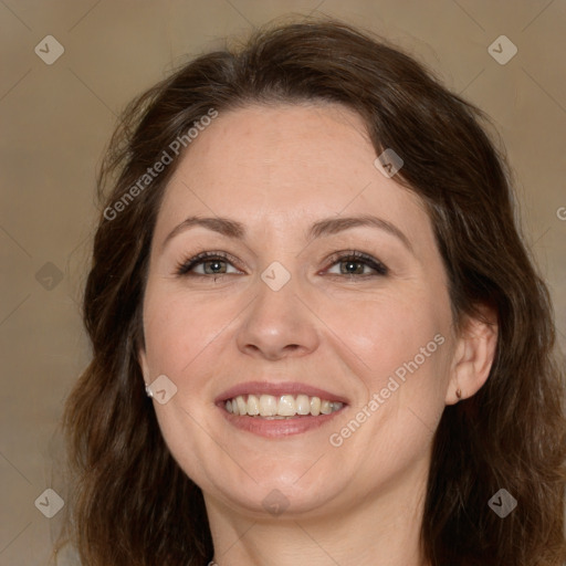 Joyful white adult female with long  brown hair and brown eyes