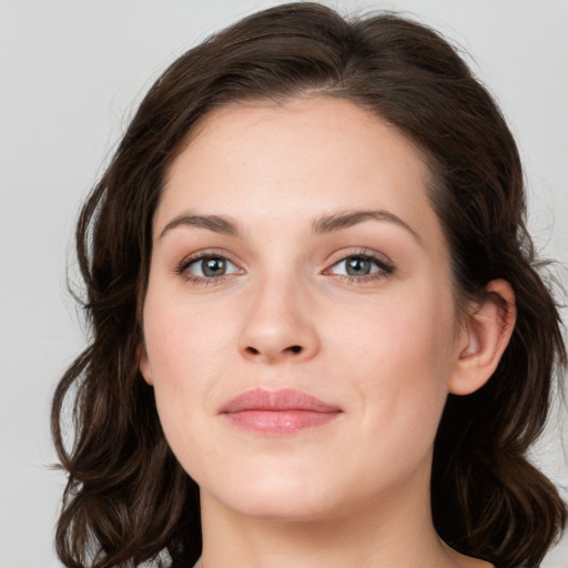 Joyful white young-adult female with medium  brown hair and green eyes