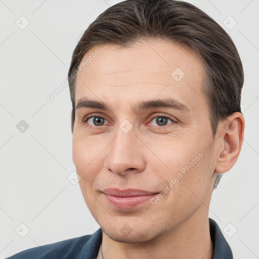 Joyful white adult male with short  brown hair and brown eyes