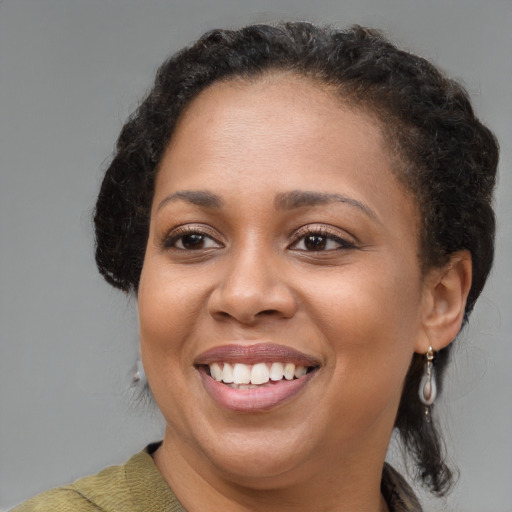 Joyful black young-adult female with medium  brown hair and brown eyes