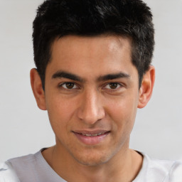 Joyful white young-adult male with short  black hair and brown eyes