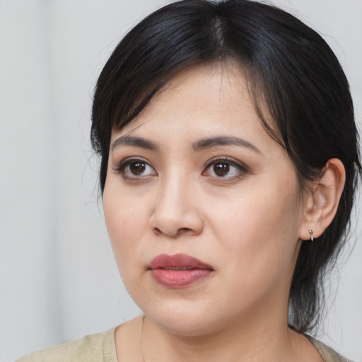 Joyful asian young-adult female with medium  black hair and brown eyes