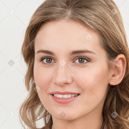 Joyful white young-adult female with long  brown hair and blue eyes