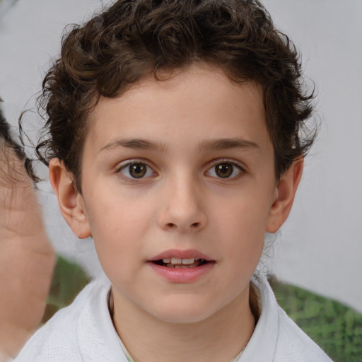 Joyful white child male with short  brown hair and brown eyes