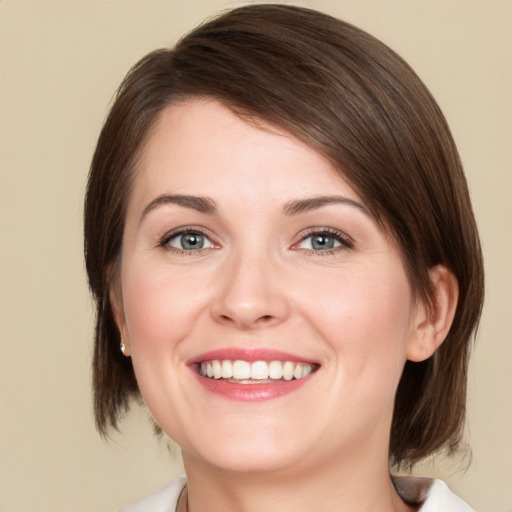 Joyful white young-adult female with medium  brown hair and brown eyes